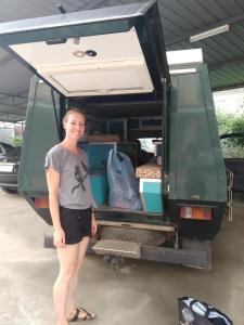 a woman standing in the back of a van at A&S Residence Kanchanaburi in Kanchanaburi City