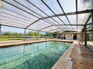 an indoor swimming pool with a retractable ceiling at CAMPING RAMALES in Ramales de la Victoria