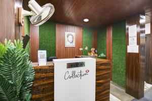 an office with a reception desk with green walls at Hotel O by OYO Sawariya Regency in Bhopal