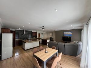 a kitchen and living room with a table and chairs at 37 On Anderson in Pretoria