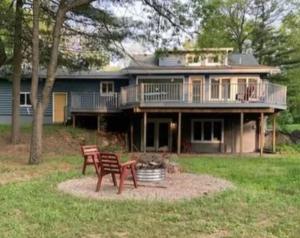 a large house with two chairs in front of it at Cookie's Cottage in Caseville