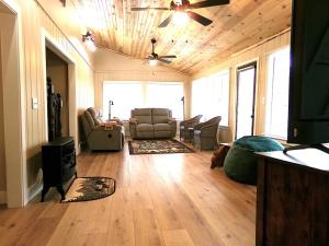 a living room with a couch and a ceiling fan at Cookie's Cottage in Caseville
