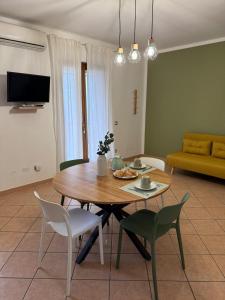 a living room with a wooden table and chairs at Casa Rina in Piano Conte