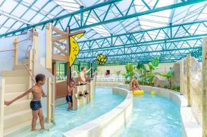 a group of children playing in a pool at a water park at Camping Le Parc de Paris in Villevaudé