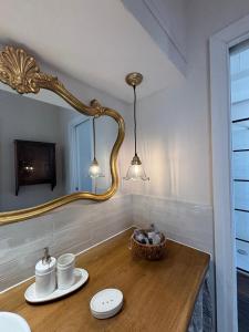 a bathroom with a mirror and a wooden table at HH Moneglia La Caletta in Moneglia +58 photos
