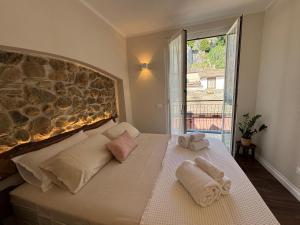 a bedroom with a bed with towels on it at HH Moneglia La Caletta in Moneglia