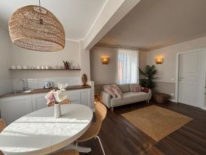 a living room with a table and a couch at HH Moneglia La Caletta in Moneglia