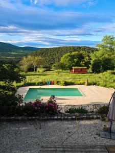 a swimming pool in the middle of a field at Les Sources chambres dhotes in Bargème