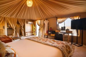 a bedroom with a large bed with a large tent at Mia Agafay Resort in El Karia +44 photos