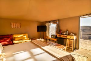 a living room with a bed and a window at Mia Agafay Resort in El Karia