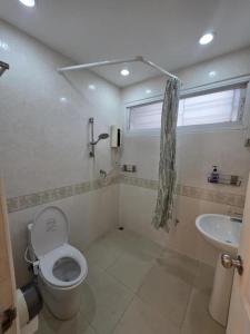 a bathroom with a toilet and a sink at Sugar Beach Villa Bangsaen in Ban Bang Saen (1) +6 photos
