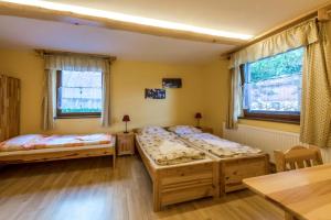 two beds in a room with two windows at Poráč Park in Poráč +110 photos