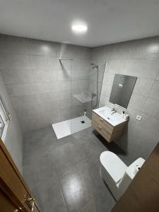 a bathroom with a toilet and a sink and a shower at Apartament Mediteranean in Valencia