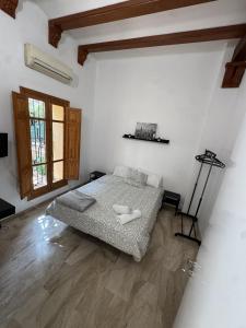 a white room with a bed and a window at Apartament Mediteranean in Valencia