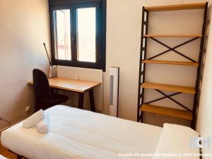 a bedroom with a bed and a desk and a window at Angel de la Guarda 18 in Soria