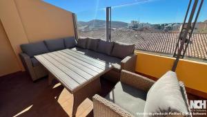 a balcony with a couch and a table and a window at Angel de la Guarda 18 in Soria