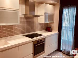 a kitchen with white cabinets and a stove top oven at Angel de la Guarda 18 in Soria +27 photos