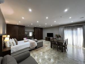 a bedroom with a large bed and a dining room at 37 On Anderson in Pretoria