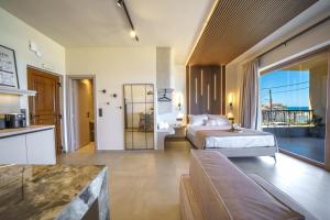 a hotel room with a bed and a balcony at Solmare beachfront apartments in Panormos Rethymno