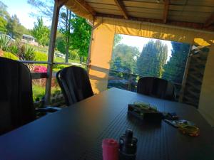 a table and chairs in a room with a window at Le petit Paradis d'Hetty in Buxières-sous-Montaigut