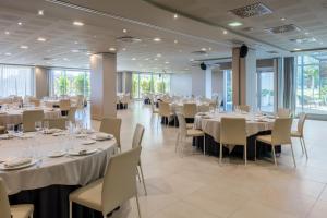 a banquet hall with white tables and chairs at Hotel SB BCN Events 4* Sup in Castelldefels