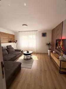 a living room with a couch and a table at Apartment Mey in Sarajevo
