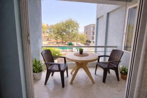 a balcony with a table and chairs on a balcony at Oasis Fun Villa - Pet Friendly Cafe in Indore