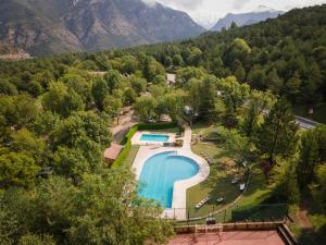 an aerial view of a resort with a swimming pool at Huttopia Barcelona Pirineos in Guardiola de Berguedà