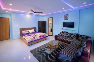 a living room with a couch and a bed at Oasis Fun Villa - Pet Friendly Cafe in Indore