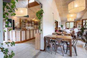a restaurant with tables and chairs and a counter at Huttopia Barcelona Pirineos in Guardiola de Berguedà