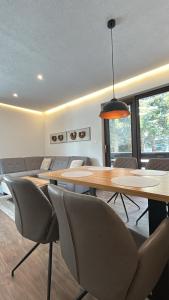 a dining room with a table and chairs at Apartmán ESKIMO in Bystrá +3 photos
