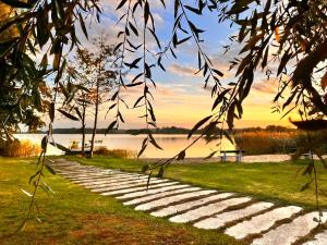 a stone path next to a body of water at Seeidyll Potzlower See in Potzlow