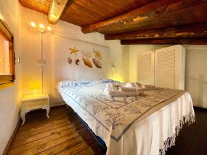 a bedroom with a large bed in a room at Punta Est - Mono TRAMONTANA Soppalco & Sea View in Capo Coda Cavallo
