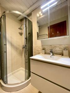 a bathroom with a shower and a sink at Punta Est - Mono TRAMONTANA Soppalco & Sea View in Capo Coda Cavallo