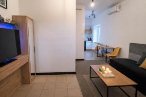 a living room with a couch and a table at Miodowa Zagroda - nocleg Zator Energylandia in Miejsce +17 photos