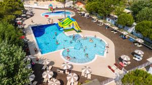 an overhead view of a swimming pool with a slide at Club del Sole Marina Family Resort in Punta Marina