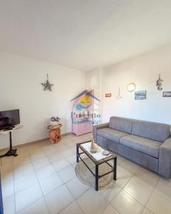 a living room with a couch and a table at Sardegna 20 in San Teodoro