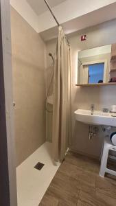 a bathroom with a shower and a sink and a mirror at Hotel Dolomiti Des Alpes in Misurina +24 photos