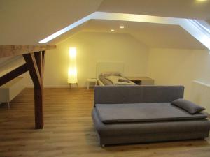 a living room with a couch and a bed at Parsberger Ferienhaus 23 a in Parsberg