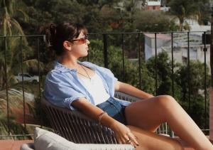 a young woman sitting on a bench at Casa Ampa Zikatela- Brisas de Zicatela- Puerto Escondido in Brisas de Zicatela