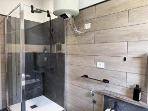 a bathroom with a shower with a glass door at Alla Rupe 8 - bilocale con vista sulle Alpi in Grosotto