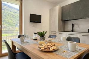 a table with a plate of food on it in a kitchen at Alla Rupe 8 - bilocale con vista sulle Alpi in Grosotto