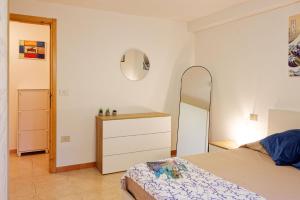 a bedroom with a bed and a dresser and a mirror at Home Garden in Cala Gonone +44 photos