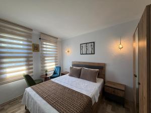 a bedroom with a bed and a table and chairs at Marina Hostel Pansiyon in Antalya