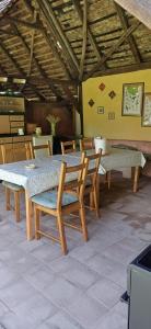 a dining table and chairs in a room at Valchid Guest House in Valchid