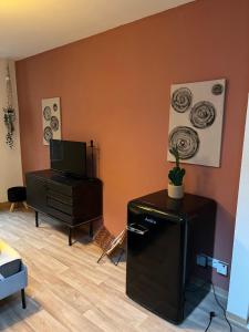 a living room with a television and a dresser at Römerburg Apartments Burgstraße in Boppard