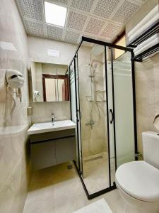 a bathroom with a shower and a toilet and a sink at Marina Hostel Pansiyon in Antalya