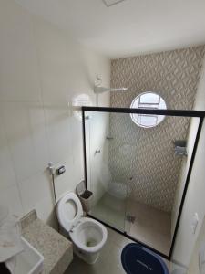a small bathroom with a toilet and a window at Casa Marco in Anápolis +20 photos