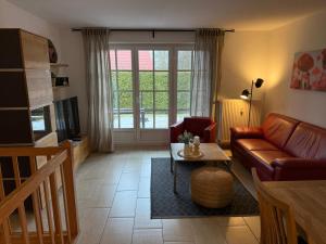 a living room with a couch and a table at Fewo 2, Achtern Diek 3a Zingst in Zingst