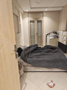 a bedroom with a bed with a blanket on it at Rabat Luxury in Salé